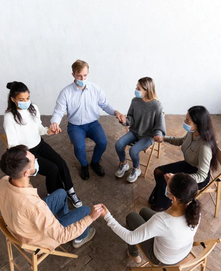 cbbcf414-68e7-4387-bfdb-3248ae905ec5-high-angle-people-group-therapy-session_23-2148752117.jpg